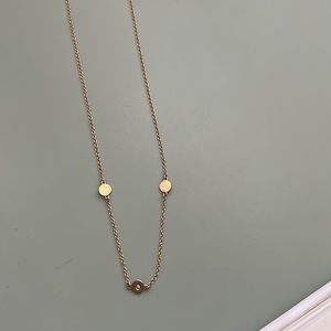 14 kt gold,16” necklace with 3 gold discs. One small diamond in the middle disc.